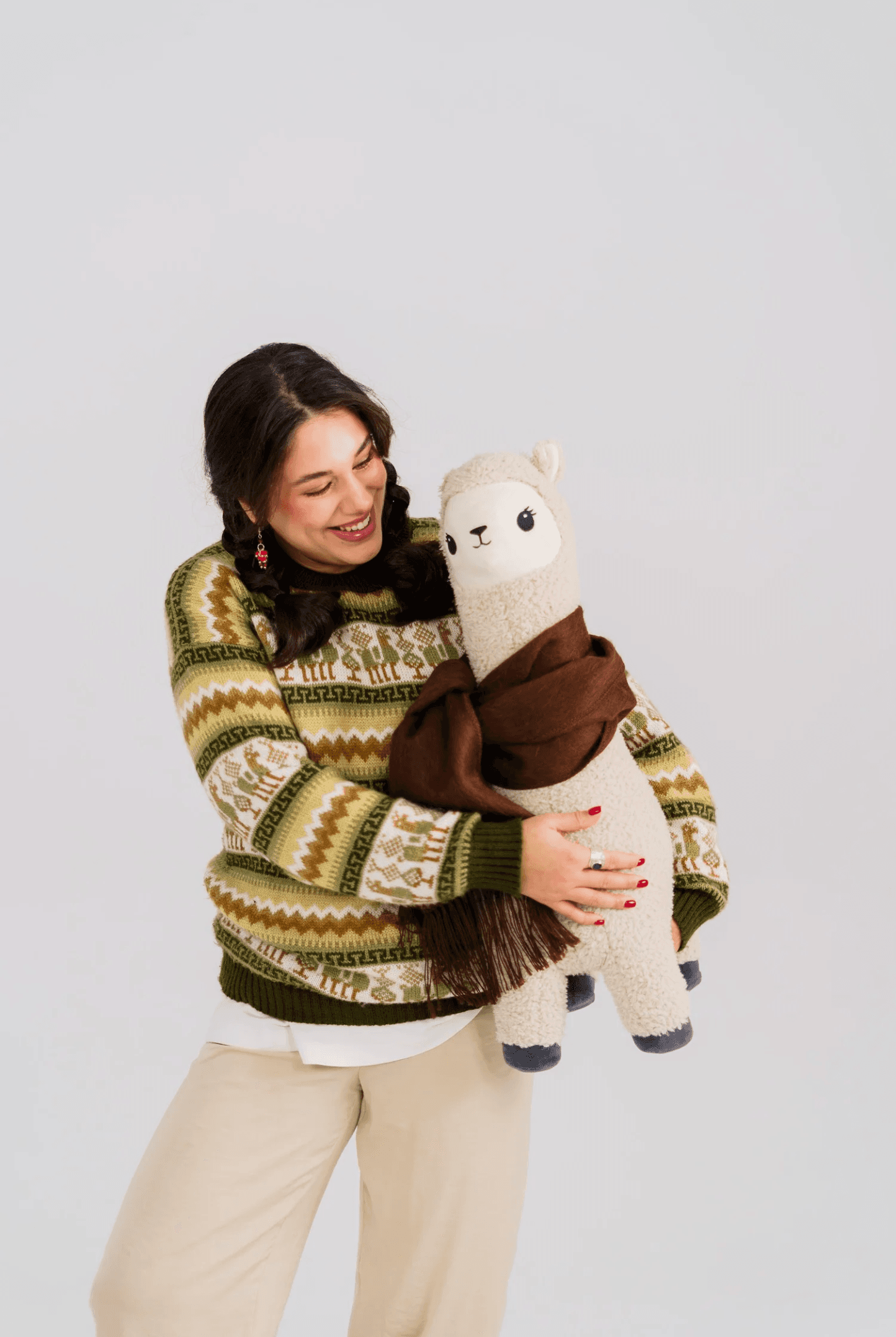 Vika holding a handwoven alpaca plush